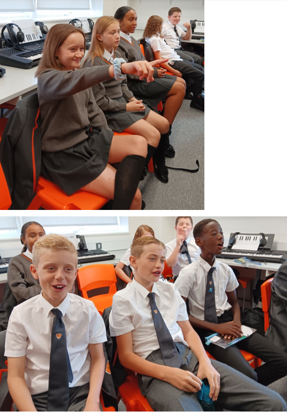 A group of children sitting in a classroom

Description automatically generated