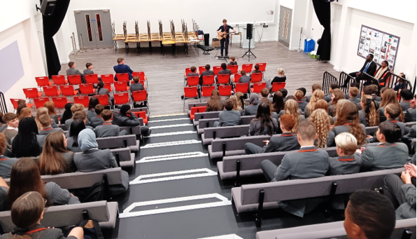 A group of people sitting in chairs

Description automatically generated