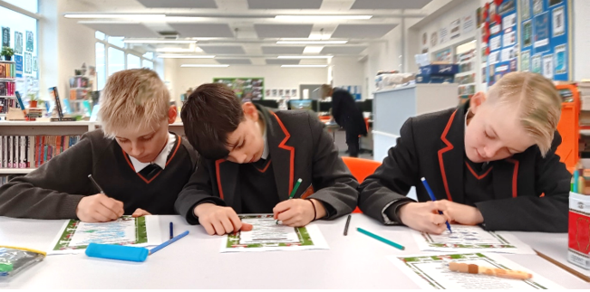 A group of boys sitting at a table

Description automatically generated