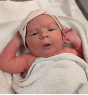 A baby wrapped in a blanket

AI-generated content may be incorrect.