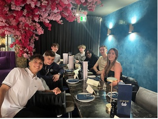 A group of people sitting at a table

AI-generated content may be incorrect.