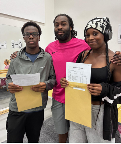 A group of people holding papers
AI-generated content may be incorrect.