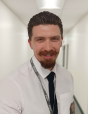 A person with a mustache and beard wearing a white shirt and tie

AI-generated content may be incorrect.