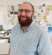 A person with a beard and glasses

AI-generated content may be incorrect.