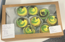 A box of cupcakes with yellow and green frosting

AI-generated content may be incorrect.
