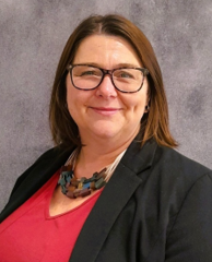 A person wearing glasses and a black jacket

AI-generated content may be incorrect.