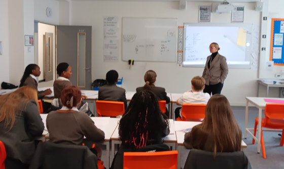 A group of people sitting in chairs in front of a whiteboard
AI-generated content may be incorrect.